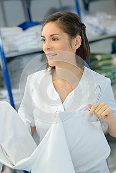 Beautiful young woman working at laundry