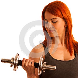 Beautiful young woman working out with dumbels in fitness gym