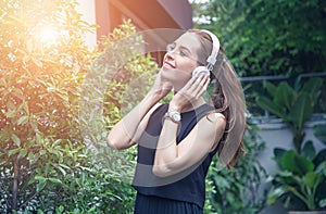 Beautiful young women in casual dress, listen to music, in parks photo