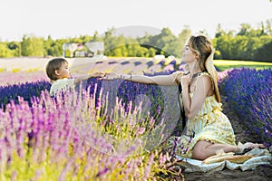 Beautiful young woman and her baby son in the lavender field photo