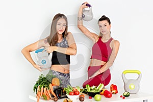 Beautiful young women with  kettle bell and healthy vegetables on white background . Diet concept. - Image