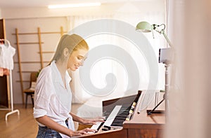 Beautiful young women playing electronic piano,Happy and smiling,Relaxation