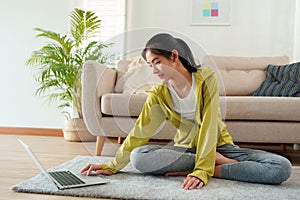 Beautiful of young women Practicing yoga online with Trainer  learning  computer laptop on a yoga mat  at home morning, Concept of