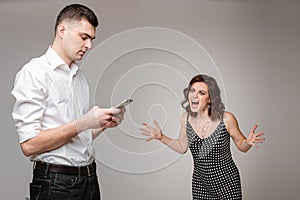 Young couple having a problem with phubbing. photo