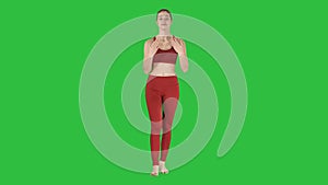 Beautiful young yoga instructor talking to camera on a Green Screen, Chroma Key.