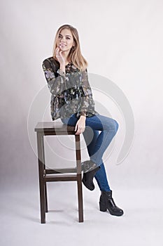 Beautiful younggirl in high chair studio
