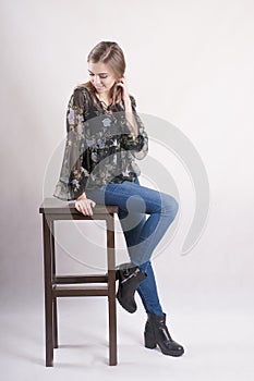 Beautiful younggirl in high chair studio blond