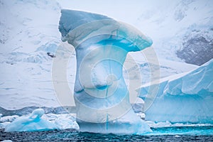 Beautifull big blue iceberg and ocean. Peculiar landscape of Antarctica