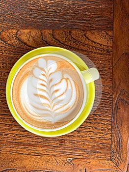 Beautifull coffee latte art on brown wood table