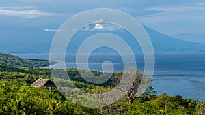 Beautifull evening view to St. Agung Vulcano on Bali from Nusa Penida Island. Partly Covered by Clouds. Indonesia