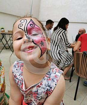 Beautifull girl with facepainting butterfly