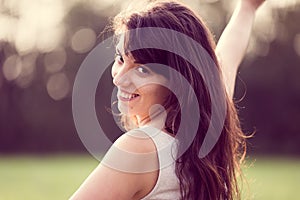 Beautifull happy smiling girl with long black hair in a garden