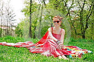 Beautifull happy young woman on green summer grass