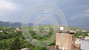 Beautifull rainbow with green scenery