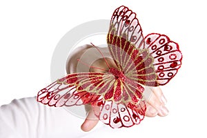 Beautifull red butterfly on woman hand