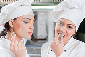 A beautifull two young female chef posing