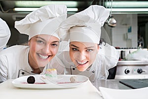 A beautifull two young female chef posing