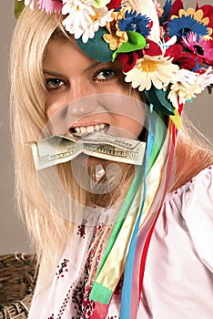 Beautifull ukrainian girl with dollar in her teeth