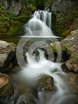 Beautifull warefall in rocky gorge.