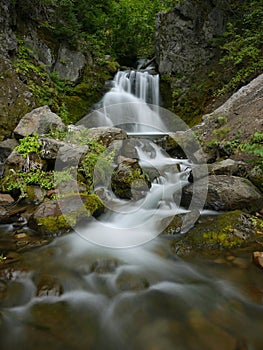 Beautifull warefall in rocky gorge.