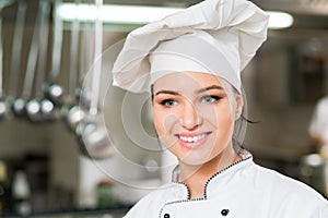 A beautifull young female chef posing for camera