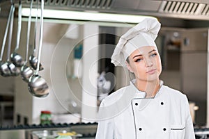 A beautifull young female chef posing for camera