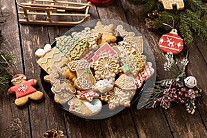 Beautifully arranged cookies in winter holidays theme, merry Christmas and happy New Year, rustic wooden background, biscuits with