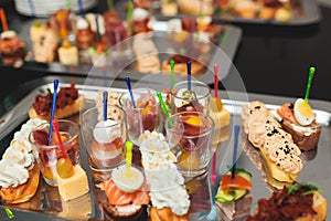 Beautifully decorated banquet catering table, with variety of with different food snacks appetizers on corporate birthday party