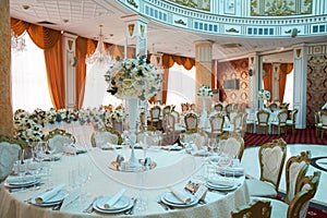 Beautifully decorated in blue green colors wedding hall with flower decoration.