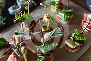 Beautifully decorated catering banquet table with different food snacks and appetizers on corporate christmas birthday party event