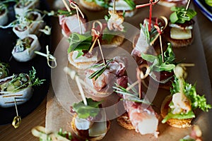 Beautifully decorated catering banquet table with different food snacks and appetizers on corporate christmas birthday party event