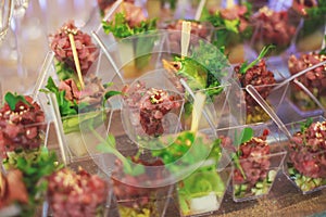 Beautifully decorated catering banquet table with different food snacks and appetizers on corporate christmas birthday party event