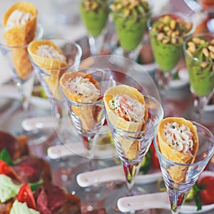 Beautifully decorated catering banquet table with different food snacks and appetizers on corporate christmas birthday party event