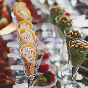 Beautifully decorated catering banquet table with different food snacks and appetizers on corporate christmas birthday party event