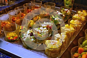 Beautifully decorated catering banquet table with different food snakes and appetizers