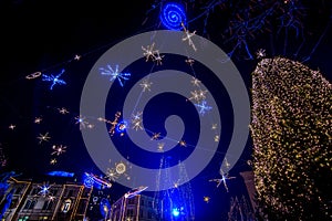 A beautifully decorated christmas tree in a town square