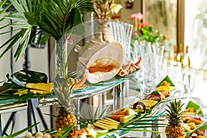Beautifully decorated delicious table with fresh exotic organic fruits on a buffet table for a party goodies