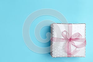 Beautifully decorated gift box on color background,