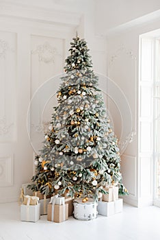 beautifully decorated room with a Christmas tree with gifts underneath
