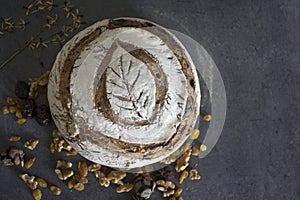 Beautifully decorated sourdough bread on gray background with copy space