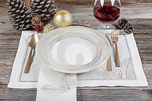 Beautifully decorated table with white plates, glasses, antique cutlery and luxury tablecloths white coral. Christmas table place