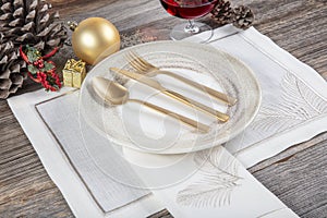 Beautifully decorated table with white plates, glasses, antique cutlery and luxury tablecloths white coral. Christmas table place