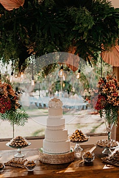 Beautifully decorated wedding ceremony table with a cake and vibrant flowers