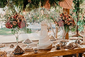 Beautifully decorated wedding ceremony table with a cake and vibrant flowers