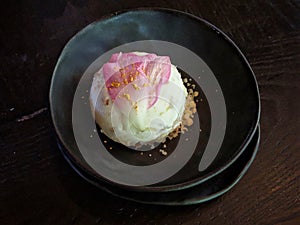 Beautifully delicious ice cream in handmade black pottery homey bowl.