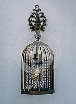 Beautifully designed brass lamp hanging on the wall