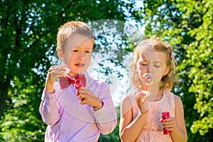 Beautifully dressed kids with soap bubbles