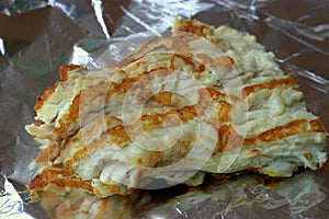 Beautifully fried fish fillet on crumpled foil