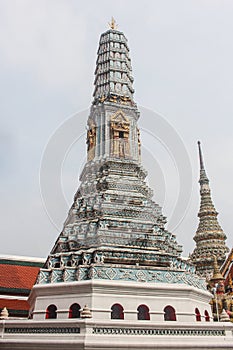 Beautifully intricate prang with golden details in Wat Phra Kaew temple. Bangkok, Thailand.