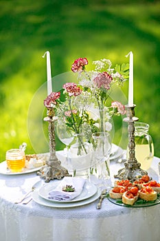 Beautifully laid a festive table for two in the garden